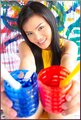 Thai girls holding paint pots smiling broadly.jpg