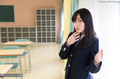 Student standing in classroom wearing uniform