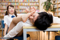 Bare feet stretched out to students face