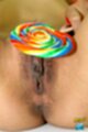 Holding lollipop over her pussy