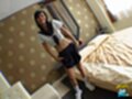 Student in uniform standing beside bed