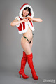 In santa outfit wearing thigh high red boots