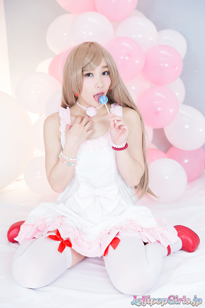 Sucking lollipop wearing dress in white stockings red high heels
