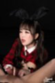 Kurumi ria kneeling holding cock looking up