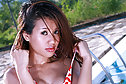 Aor Chan strips bikini beside pool on sun lounger