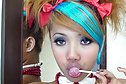 Air sucking lollipop with her hair in pigtails