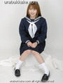 Kogal seated in uniform hands on her lap wearing socks and shoes.jpg